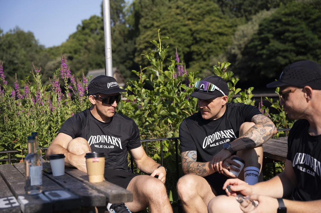 Runner in black Ordinary Mile Club kit with a post-run coffee, Inverness-shire coffee shop guide