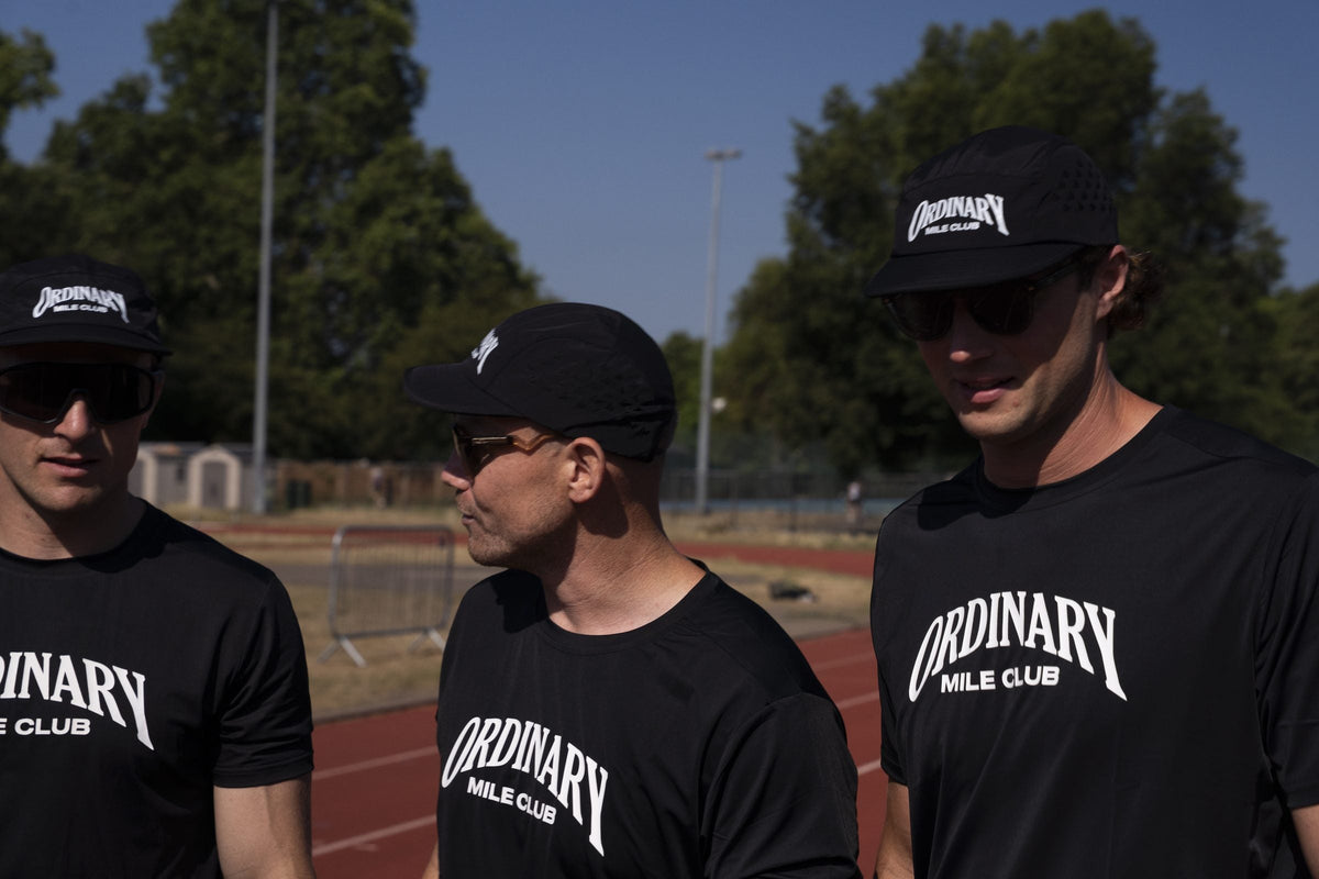 Group of Ordinary Mile Club runners training together on a track during a 10K training session