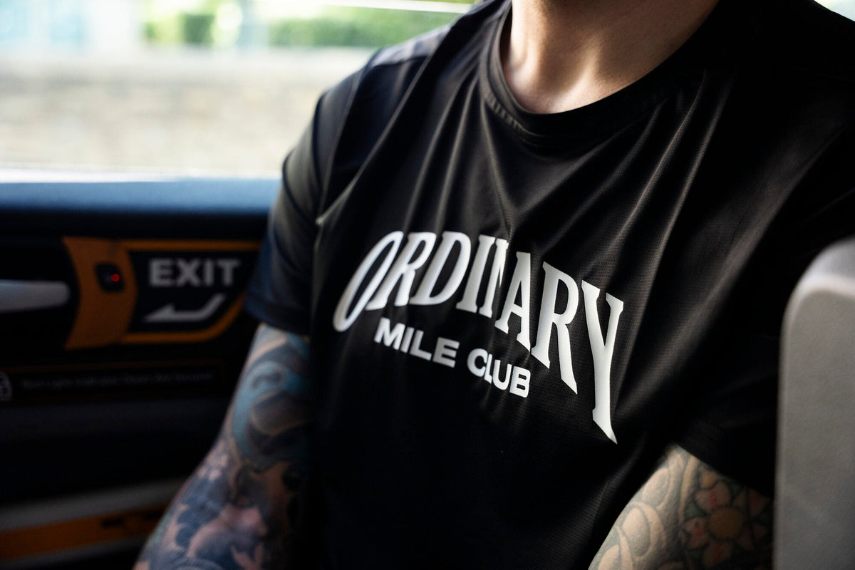 Runner in Ordinary Mile Club kit after a run in Surrey